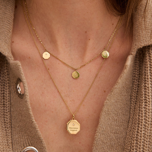Layered 18-carat yellow gold octagonal pendant necklaces on a woman’s neck with fine chain jewelry. - Médaille My Poinçon 22